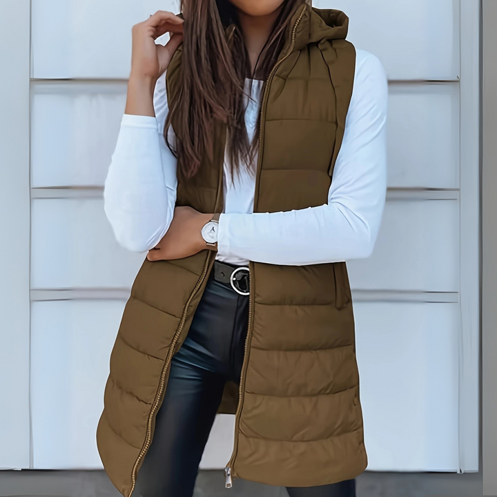 Chic women's long hooded puffer vest, ideal as a lightweight outerwear layering piece for versatile fall fashion.