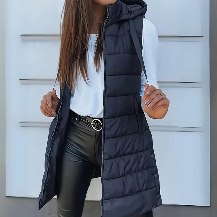 Woman wearing a casual lightweight hooded long puffer vest, excellent for fall & winter layering and warmth.
