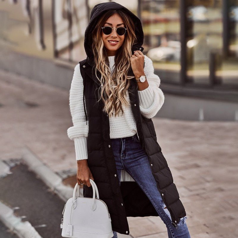 Women's long hooded puffer vest, stylish and warm for winter layering outerwear.
