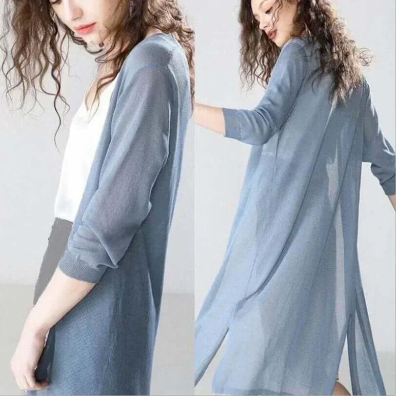 Woman wearing a long open front cardigan sweater, showcasing elegant fall layering and style.