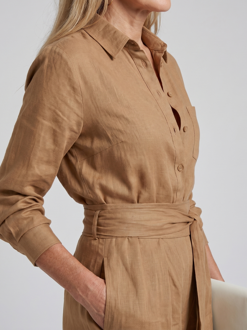 Women's comfortable long sleeve wide leg jumpsuit. Button front adds detail to this relaxed fit one-piece.