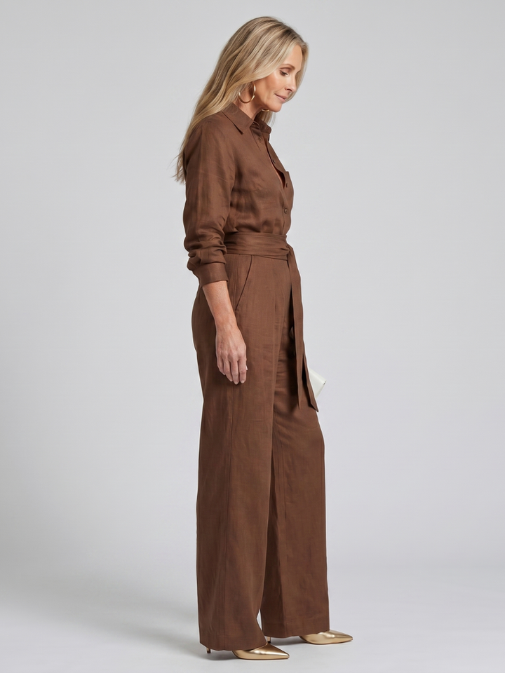 Relaxed fit women's long sleeve wide leg jumpsuit. Comfortable button-front design for all-day chic.