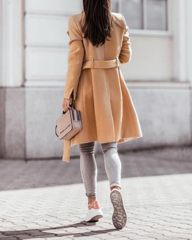 Stylish women's longline double-breasted coat with waist tie, perfect for sophisticated winter fashion.
