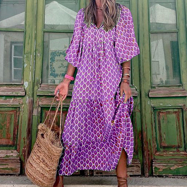 Comfortable women's loose fit midi dress, featuring a detailed print, three-quarter sleeves, and a stylish ruffled hem.