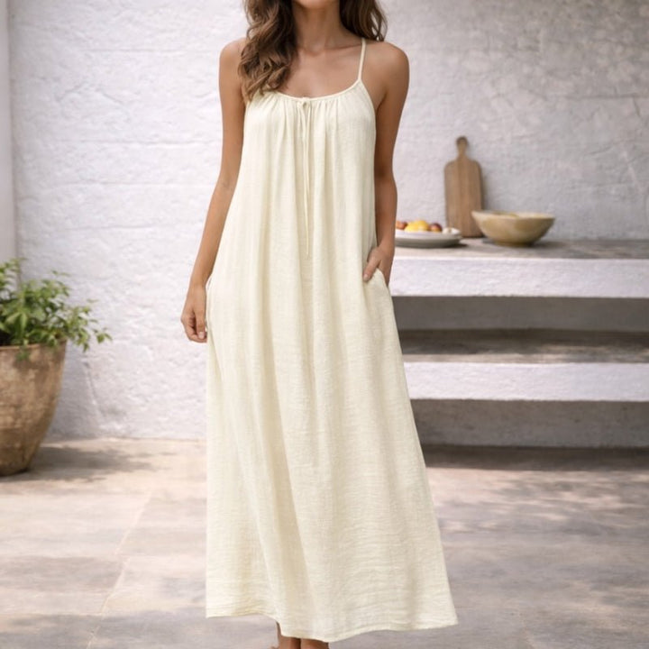 Versatile women's loose-fit maxi dress with spaghetti straps & pockets. Ideal for beach, casual, or travel.
