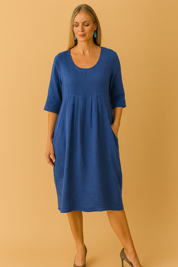 Casual women's knee-length dress featuring a relaxed fit, round neckline, short sleeves & handy pockets. Perfect for everyday.