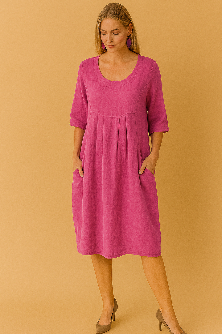 Feminine short sleeve loose dress with a round neckline and useful side pockets, offering comfort and style for women.
