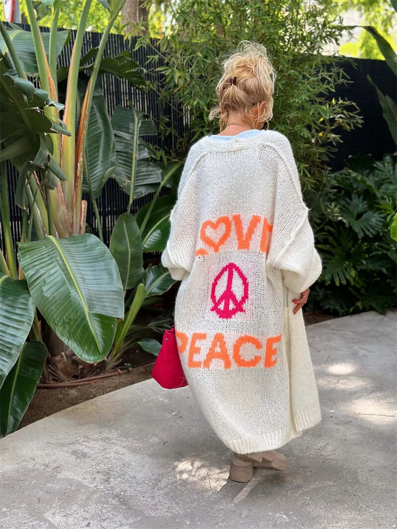 Stylish women's Love & Peace graphic cardigan. Cozy open-front sweater, ideal for fall fashion or spring outfit layering.