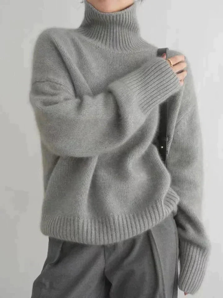 Model wearing an elegant women's long-sleeve turtleneck sweater, perfect for sophisticated winter & fall fashion.