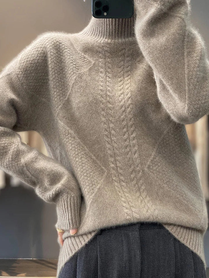 Luxury women's cable knit cashmere jumper. Super soft and warm roll neck sweater for winter fashion.