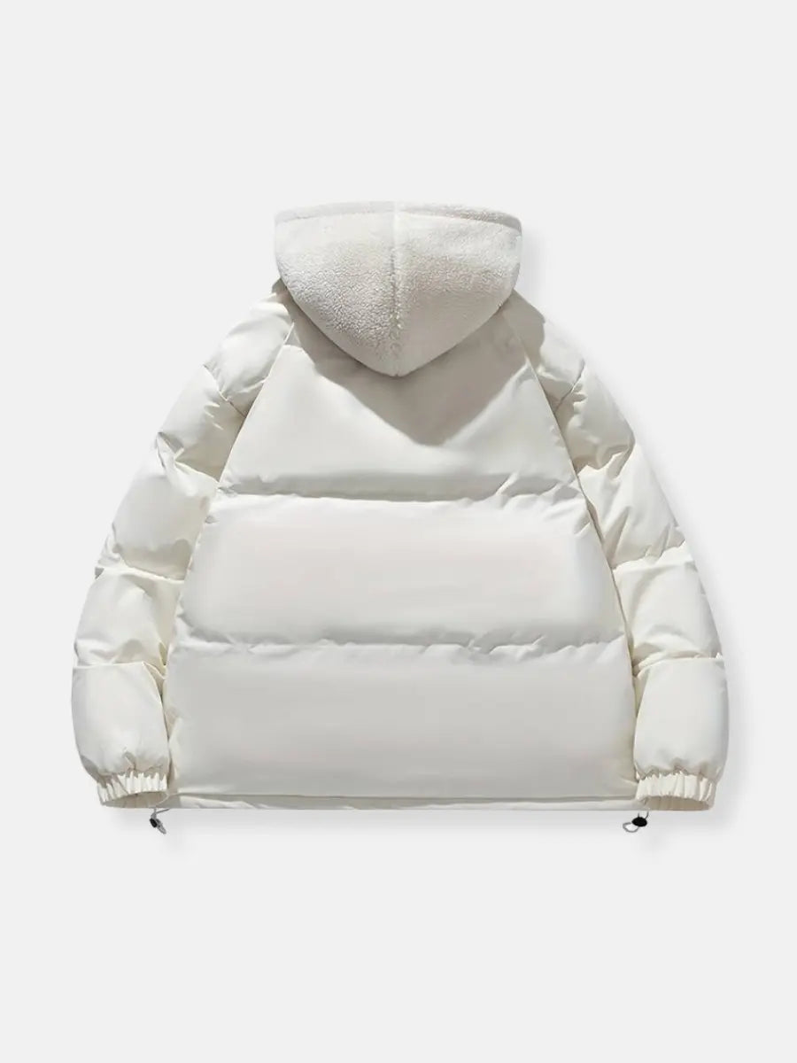 Padded women's winter jacket, stylish and cozy, great for cold weather trips.