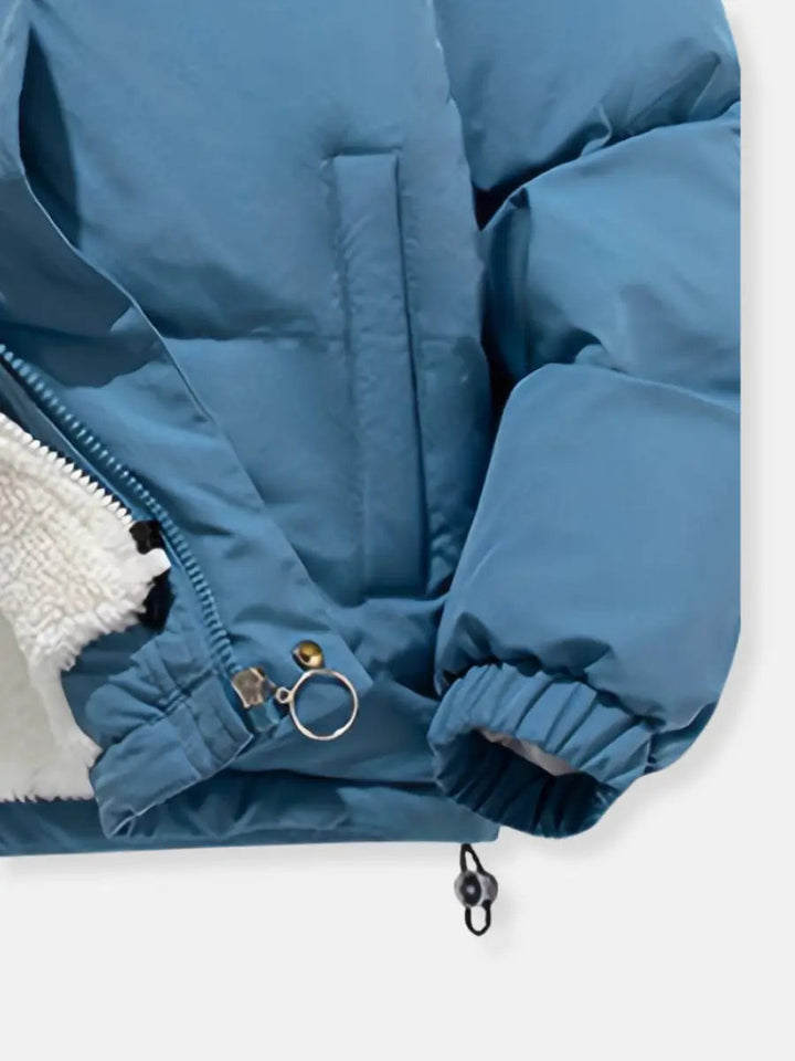 Women's hooded puffer jacket, warm, stylish, and perfect for cold weather travel.