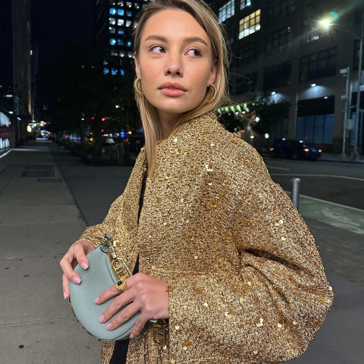 Chic metallic women's jacket with an elegant tailored fit. Ideal mid-season outerwear for versatile fashion.