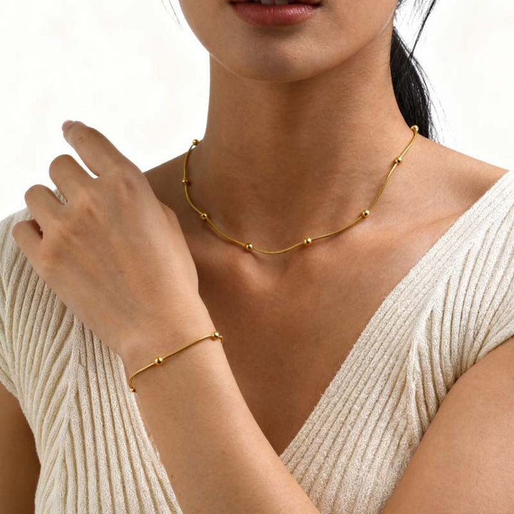 Women's minimalist charm bracelet, anklet & necklace set. Elegant gold tone fashion jewelry.