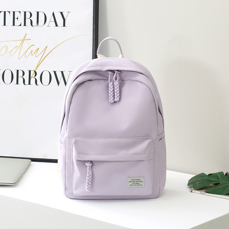 Women's minimalist everyday backpack, stylish & functional for daily use, work, or college. Sleek black design.