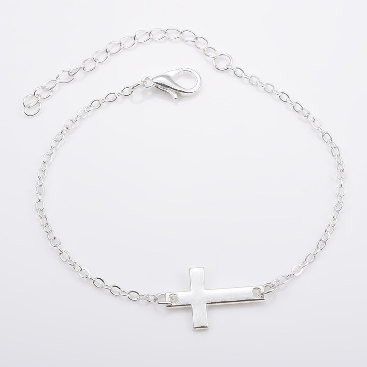 Stylish silver cross charm bracelet for women, adjustable minimalist jewelry, perfect spiritual gift.