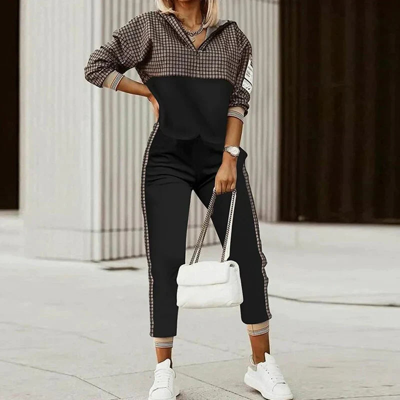 Stylish women's two-piece tracksuit featuring a zipper jacket & matching joggers. Ideal for activewear or casual comfort.
