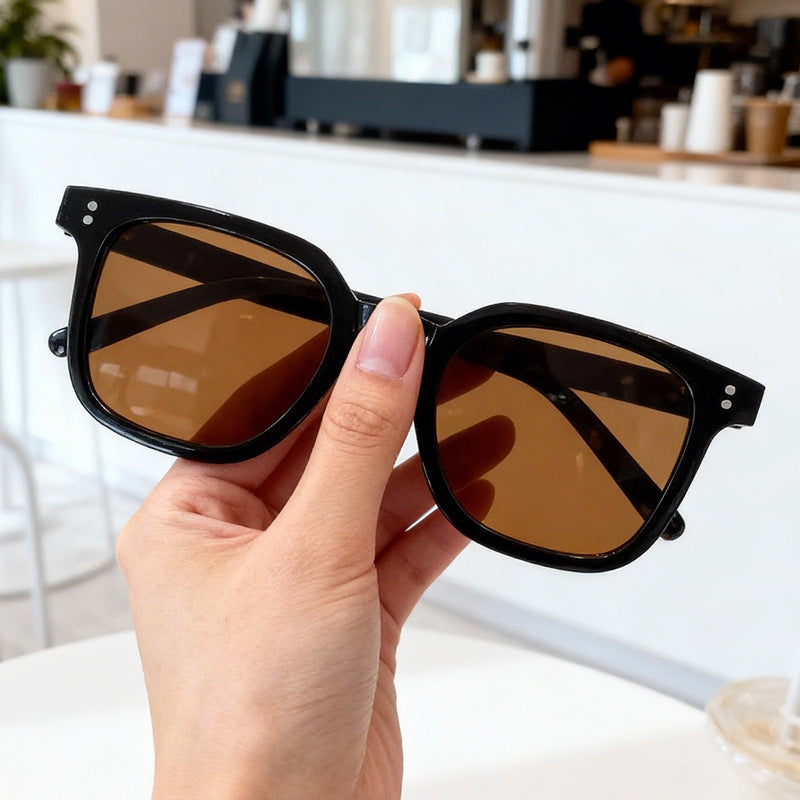 Women's modern oversized square sunglasses, chic black frame, perfect for a trendy summer style & UV protection.