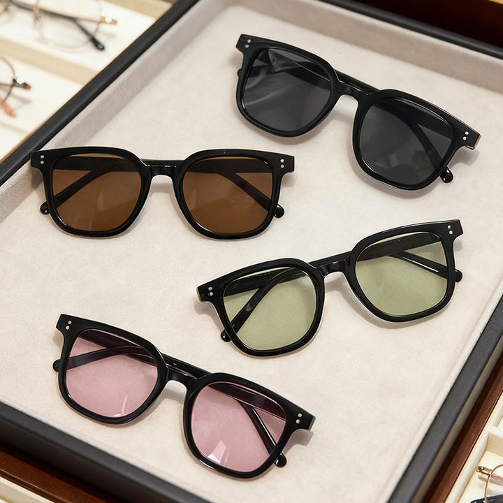 Trendy women's oversized square sunglasses with UV protection, black frame for chic summer eyewear.