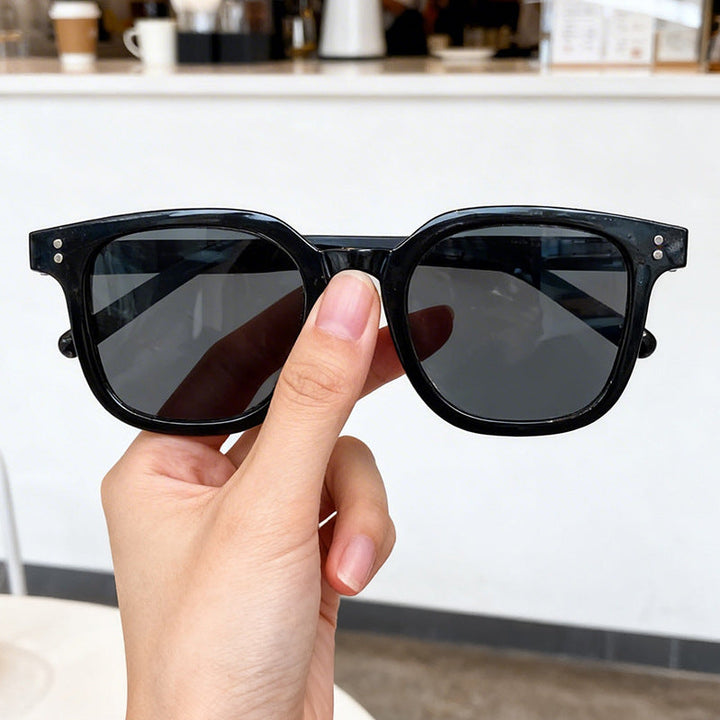 Sleek black oversized square frame sunglasses for women, offering chic style and essential UV protection.