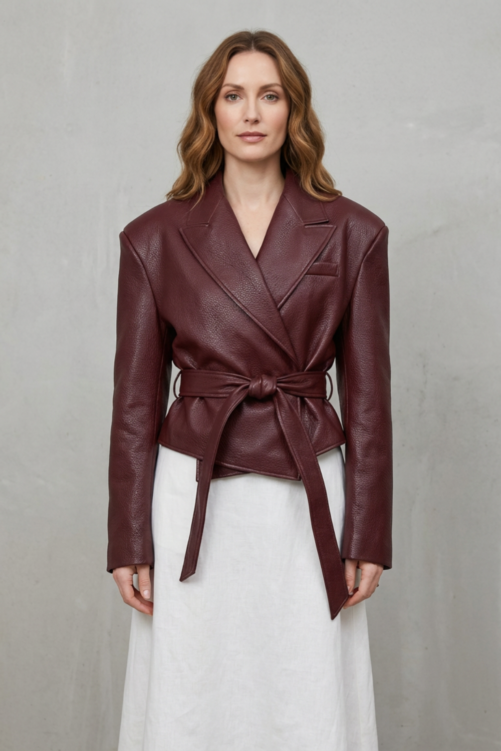 Stylish women's belted jacket with a sculpted modern fit, highlighting a chic silhouette.