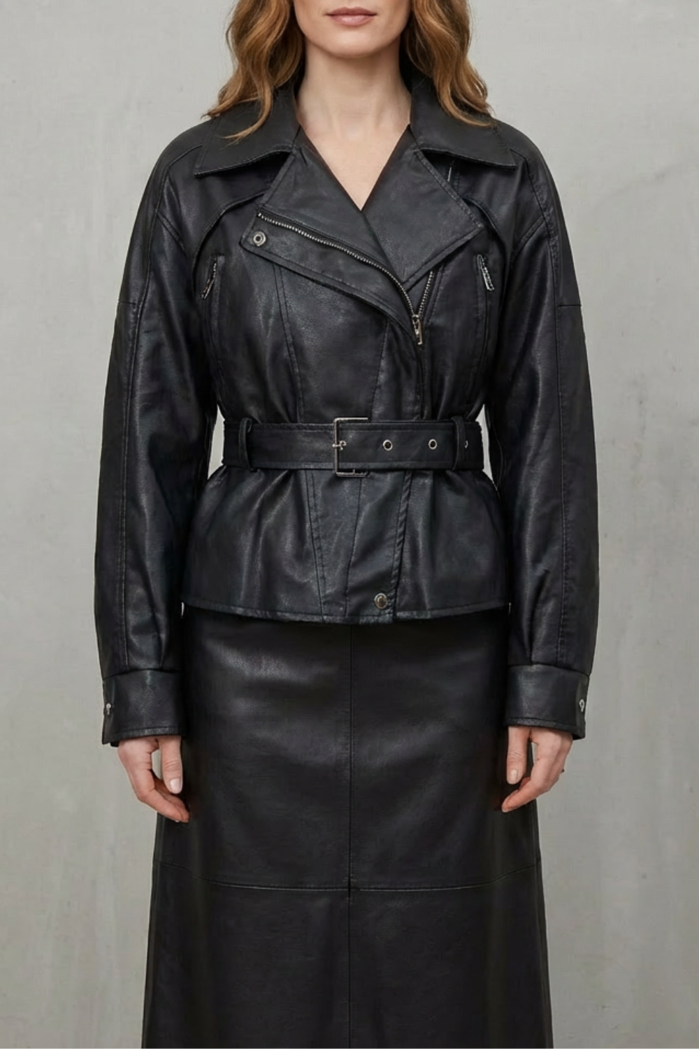 Close-up of the elegant belt on a women's modern sculpted jacket, highlighting quality and style.