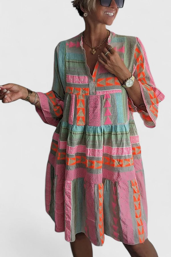 Flowy multi-color women's boho tiered dress with a comfortable fit. Stylish bohemian summer casual wear.