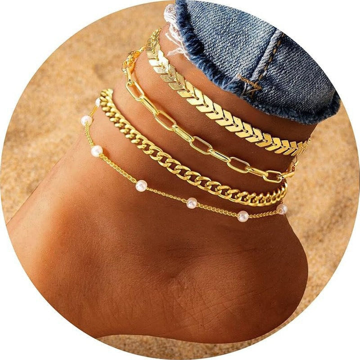 Elegant women's gold multi-layered anklet set, perfect for a chic summer look or everyday wear.