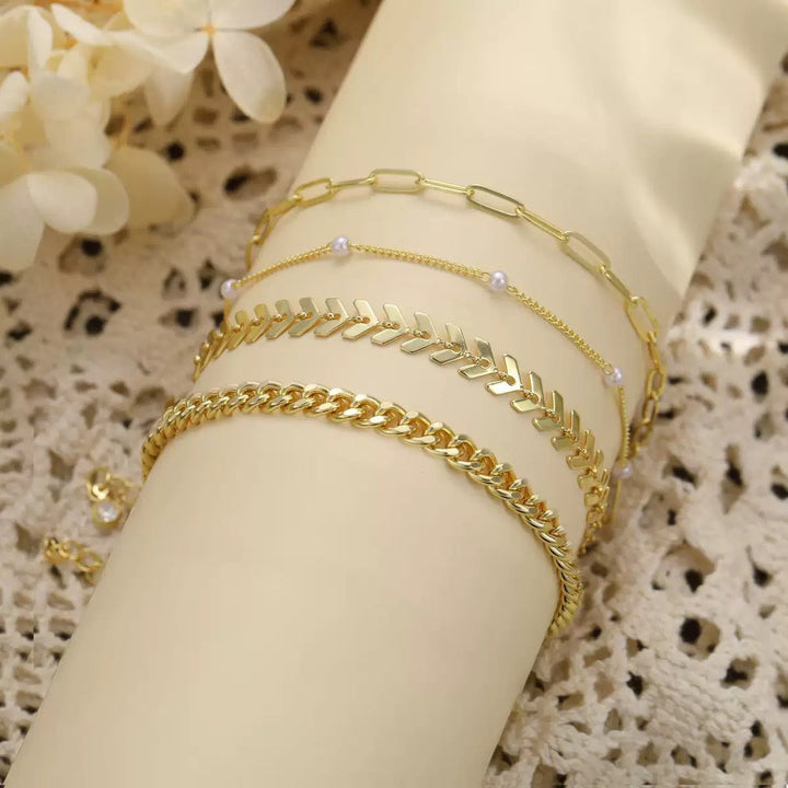 Adjustable multi-layer silver chain anklet set with delicate pearl accents, a stylish women's accessory.