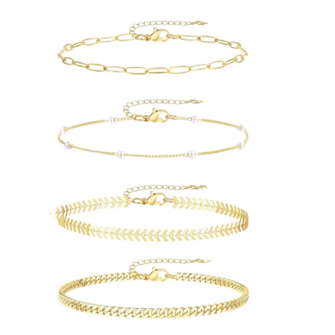 Dainty multi-layered ankle bracelets in gold & silver tones, a versatile women's fashion accessory set.