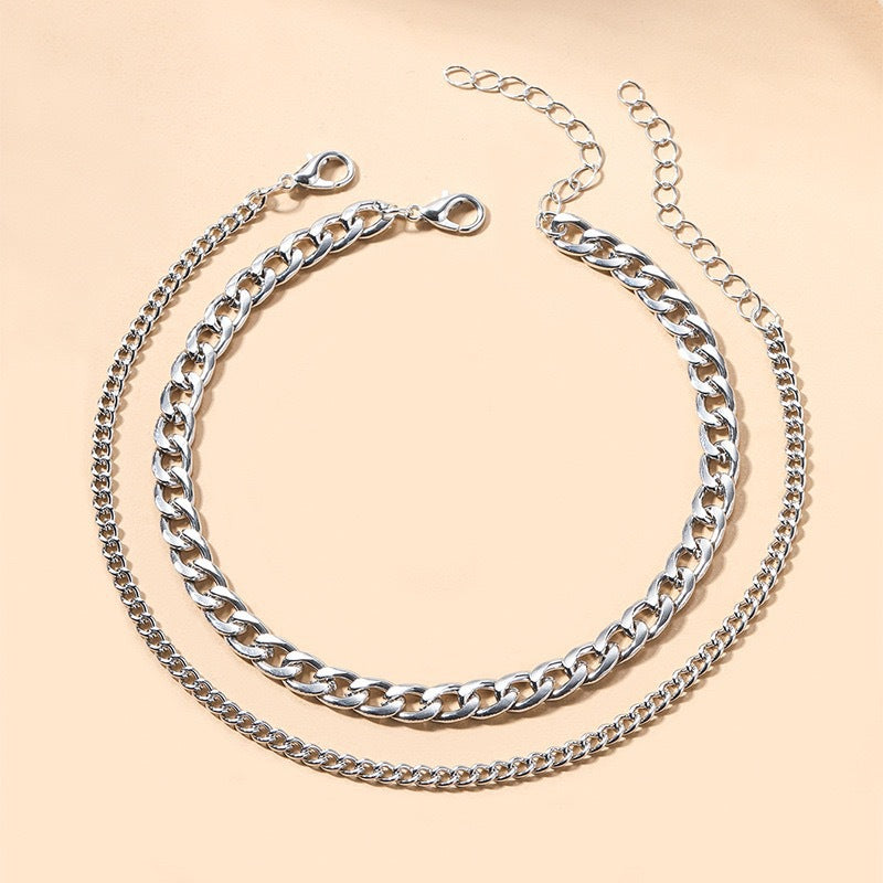 Multi-layered silver and gold chain necklace. Women's elegant fashion jewelry, perfect for layering.