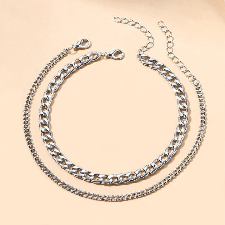 Intricate multi-layered chain necklace for women. Silver and gold tones, luxurious jewelry statement.