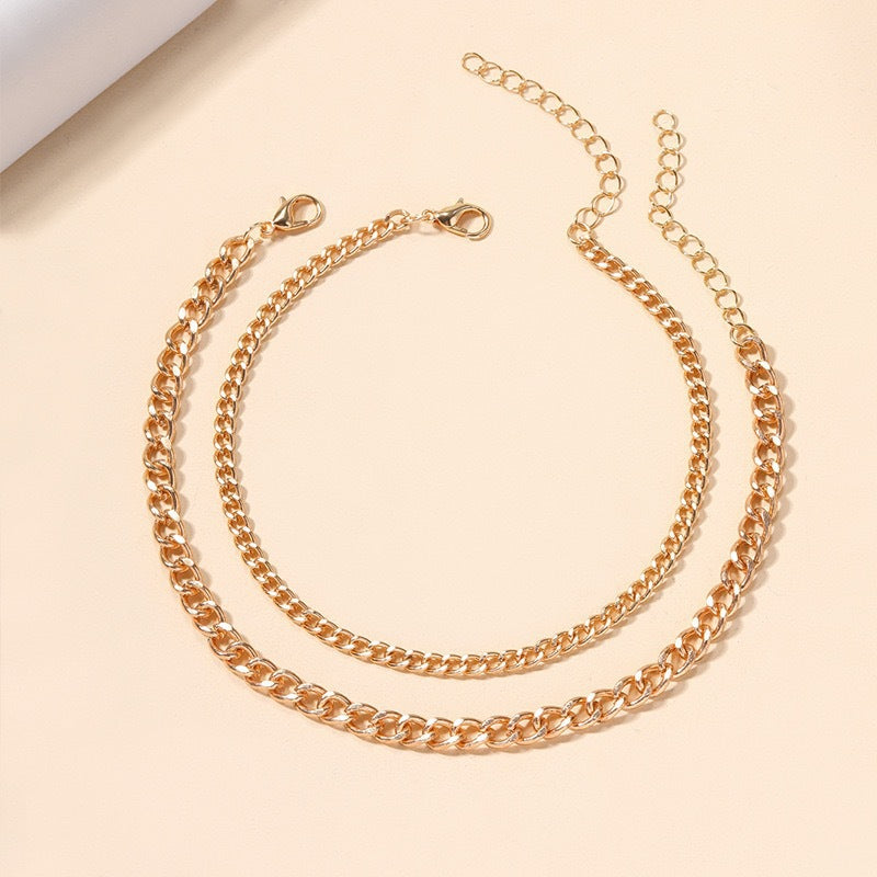 Women's multi-layered silver & gold chain necklace, a versatile elegant fashion jewelry statement piece.