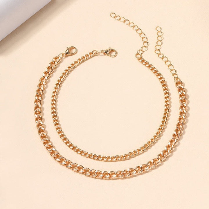 Women's multi-layered silver & gold chain necklace, a versatile elegant fashion jewelry statement piece.