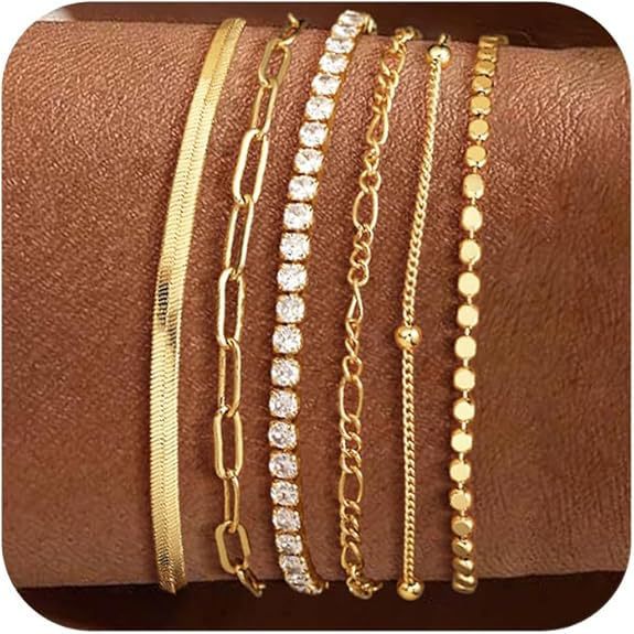 Dainty layered silver & gold charm bracelets for women, a stylish and elegant jewelry fashion accessory.