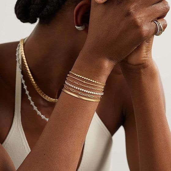 Fashionable multi-layered charm bracelet set for women, featuring both silver and gold tones.