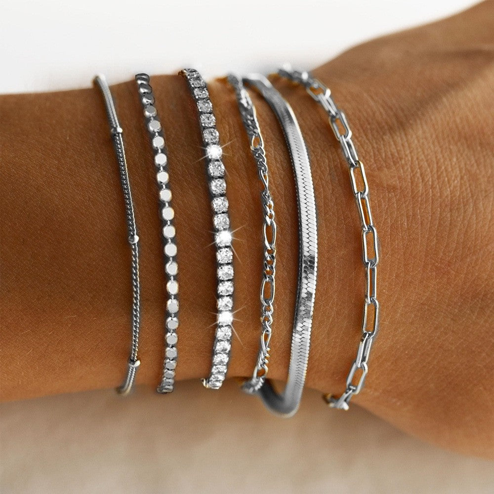 Modern multi-strand women's charm bracelet set in elegant silver & gold, versatile fashion jewelry.