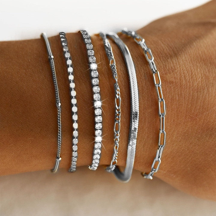 Modern multi-strand women's charm bracelet set in elegant silver & gold, versatile fashion jewelry.