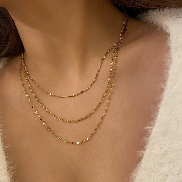 Elegant women's layered gold necklace, delicate chain accessory with pearls for a stylish look.