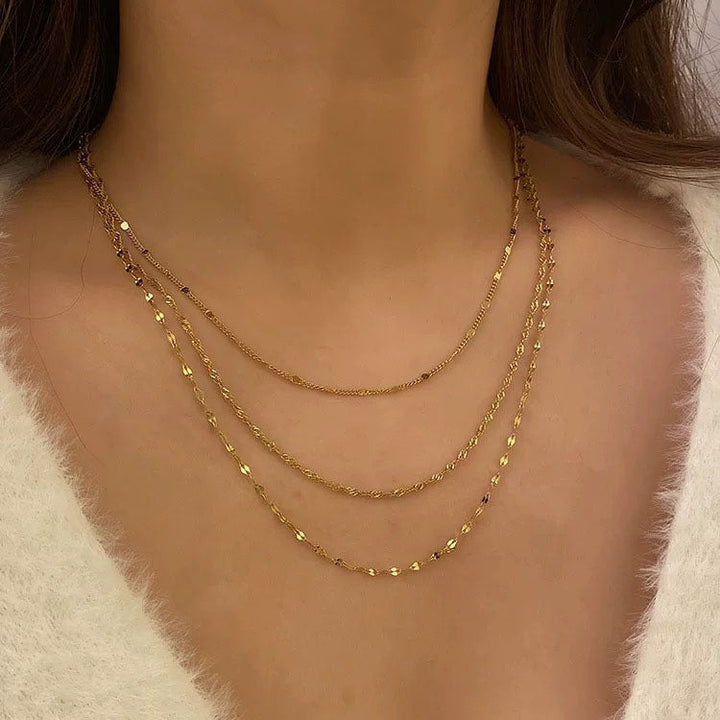 Gold multi-layer chain necklace for women, a trendy jewelry accessory with elegant pearl accents.