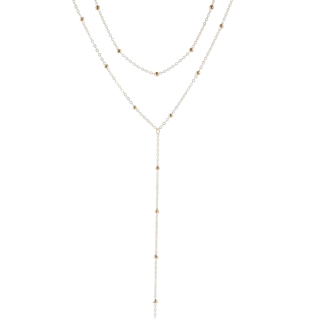 Chic multi-layered gold lariat charm necklace, a delicate yet striking accessory for women's fashion.