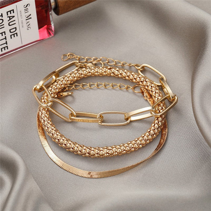 Stylish layered chain bracelet set for women, adjustable, with diverse textures and finishes.