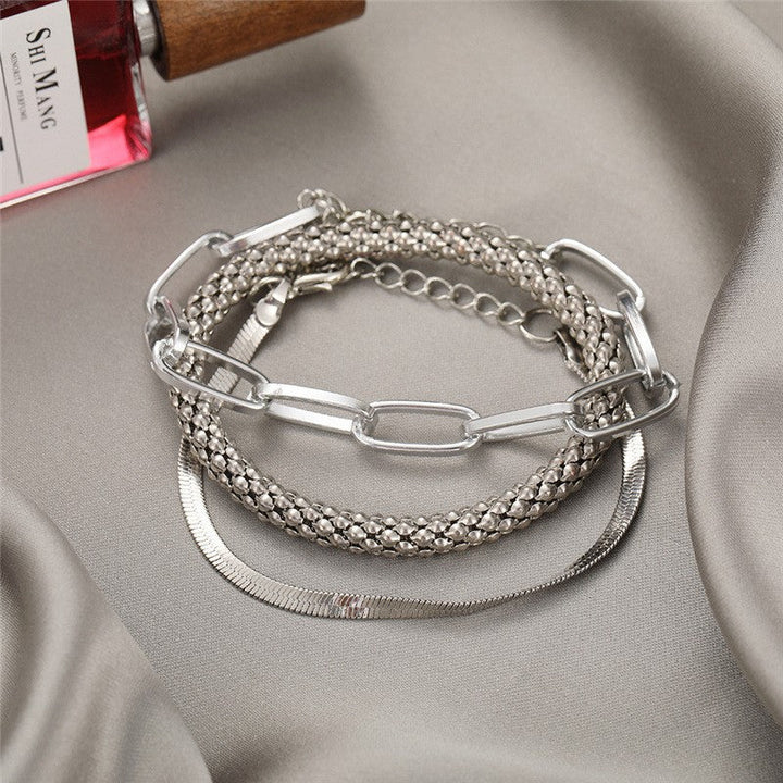 Contemporary multi-textured chain bracelet set for women, adjustable, complementing any outfit.