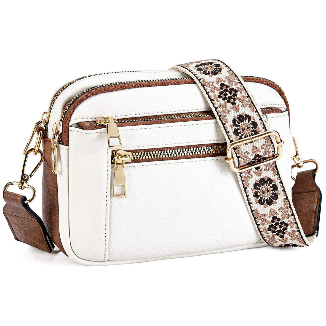 Women's multi-zip crossbody bag with stylish printed strap; a trendy and functional fashion accessory.