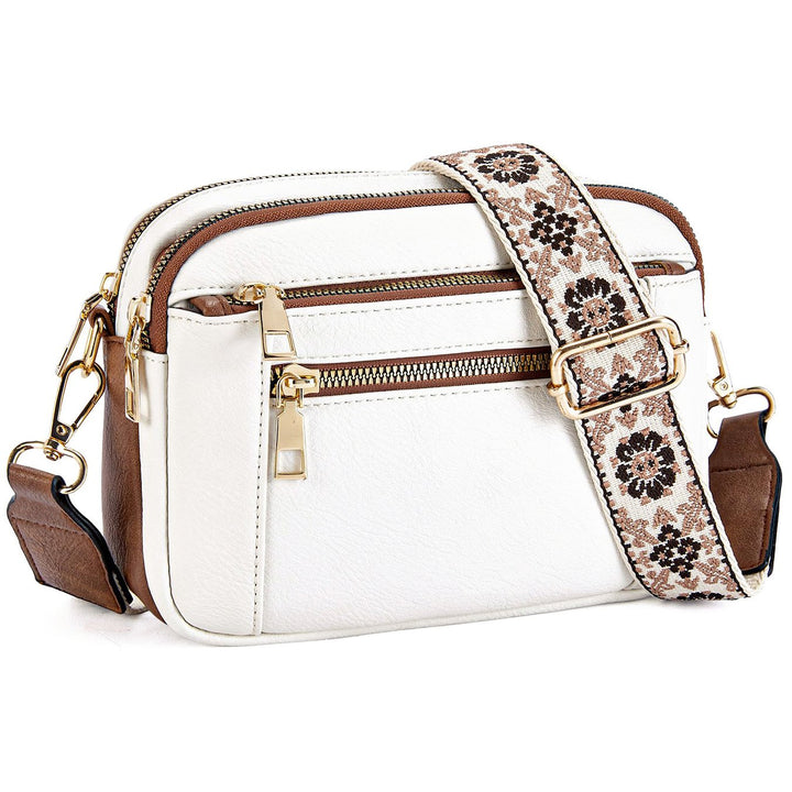 Women's multi-zip crossbody bag with stylish printed strap; a trendy and functional fashion accessory.