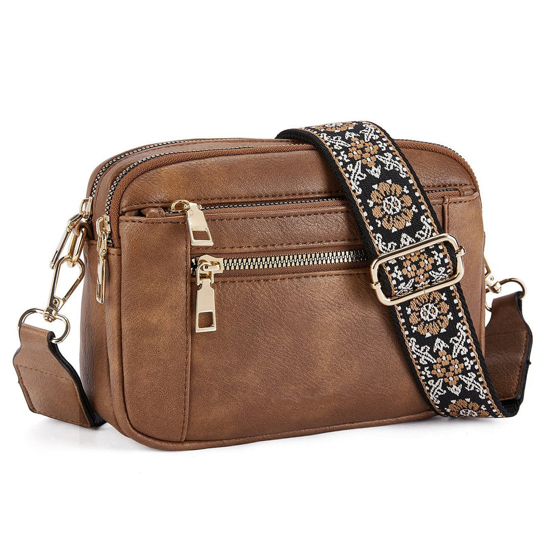 Chic women's crossbody handbag featuring a unique printed strap and multiple zips; perfect for everyday style.