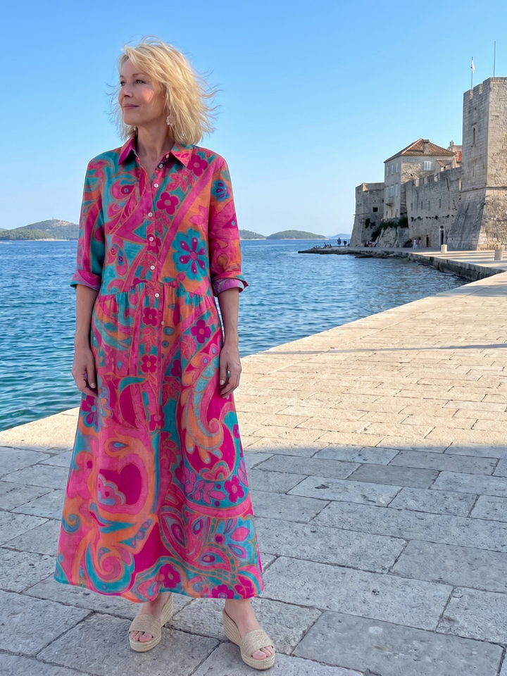 Versatile women's printed midi dress, collared & button-front, offering relaxed fit for stylish summer and travel wear.