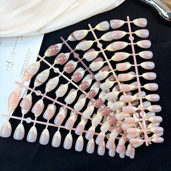Elegant natural glossy press-on nails for women. Achieve a beautiful, instant manicure with these fake nails.