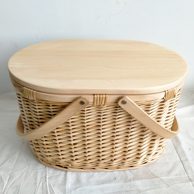 Spacious oval brown & white woven picnic basket, sturdy wooden lid, great for women's park trips & outdoor dining.