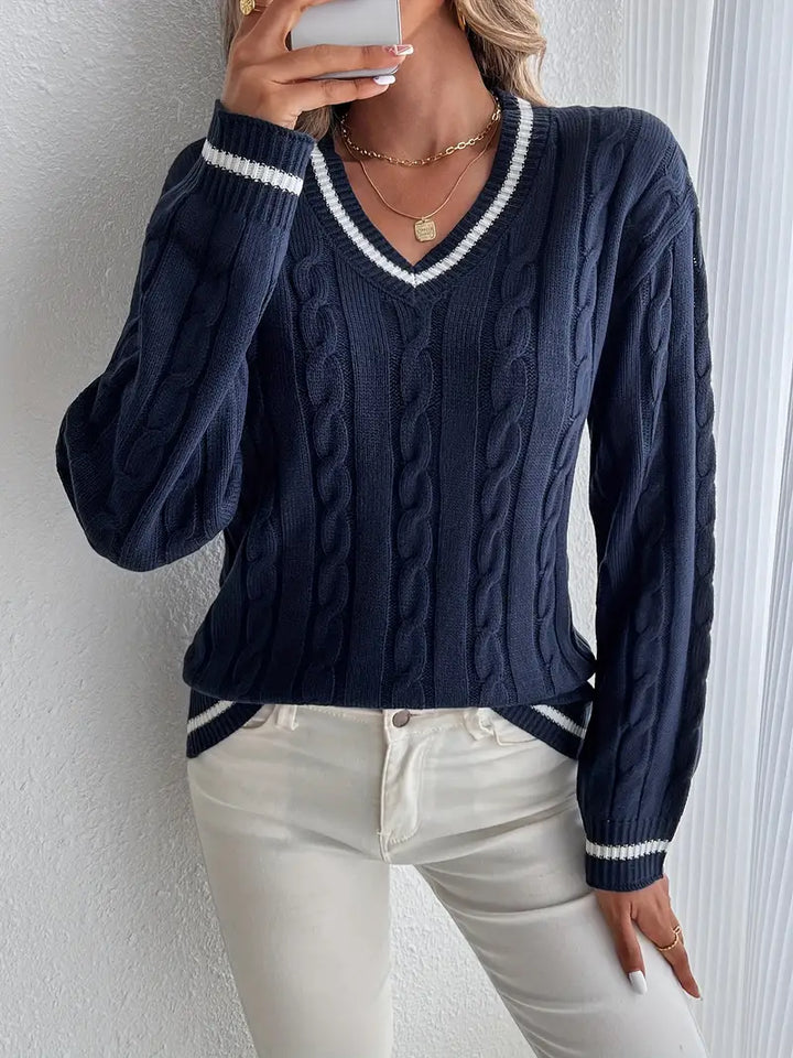 Women's navy blue V-neck cable knit sweater with striped trim, long sleeve, perfect for fall and winter fashion.